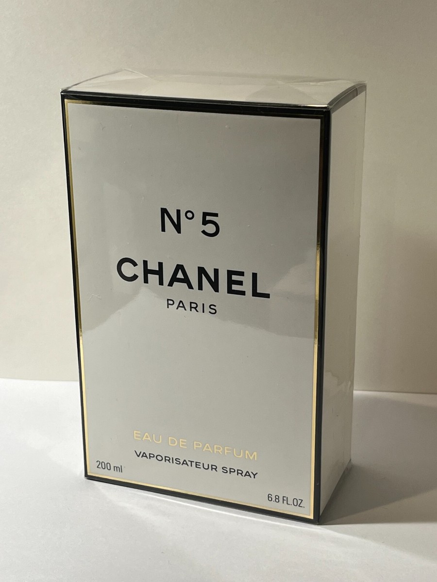 A sealed box of Chanel No. 5 Eau de Parfum, 200 ml (6.8 fl oz), with a white background and black and gold accents on the packaging. Marketing Made Clear A sealed box of Chanel No. 5 Eau de Parfum, 200 ml (6.8 fl oz), with a white background and black and gold accents on the packaging. Marketing Made Clear