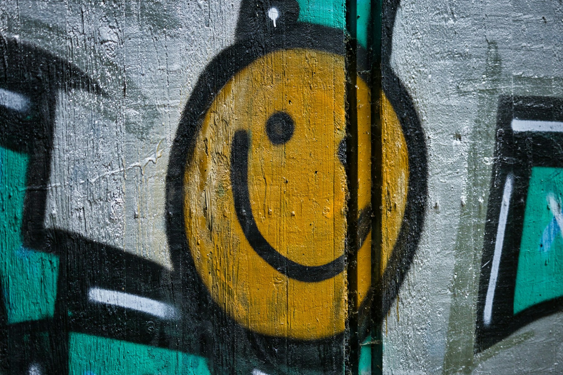 Simple smiley face painted on a concrete wall