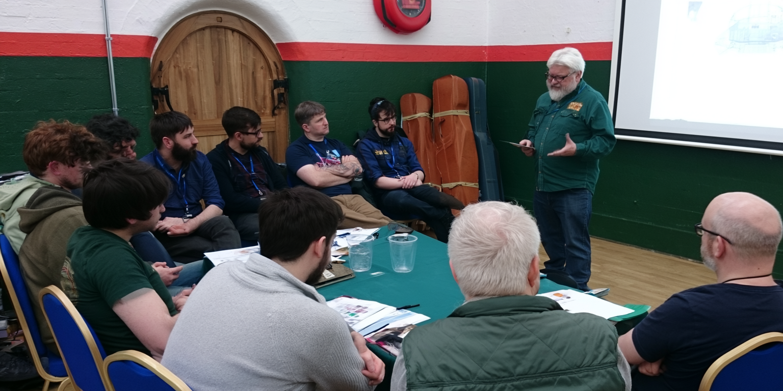 University student defending work in discussion with academic staff